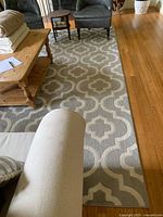 View of the rug in a living room setting showing full pattern and size relative to furniture.