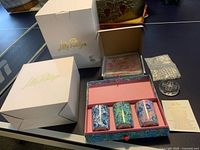Photo of three Lily Pulitzer scented candles in a decorative box with original packaging and brand box.