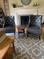 Front view of both gray tufted occasional chairs in living room