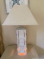 Side view of beach themed lamp showing tree-trunk style lamp base and trapezoid shade