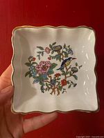 Top view of the Aynsley Pembroke trinket box interior showing floral and bird decoration on white bone china with scalloped edges and gold trim