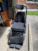 Front view of Fuse T50 wheelchair showing padded seat, leg rests, and adjustable headrest