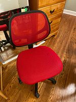 Front view of office chair showing red fabric seat and red mesh backrest with black plastic base and wheels.