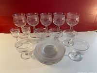 Photo of the full vintage Bryce glassware set showing five large etched goblets, two mini glasses, five champagne glasses, and seven dessert plates