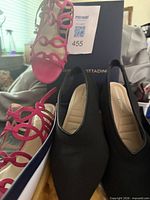Black Adrienne Vittadini heels and pink strappy sandals side by side