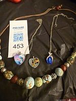 Overview of all four necklaces displayed