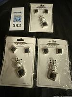 Three Icon Collection sets in packaging showing earrings and pendant designs
