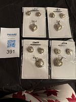 All four carded heart jewellery sets with MaxSold lot slip visible