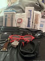 Overall lot showing packaged and loose watch bands, protective bezels, eyewear
