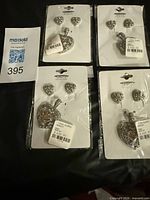Four sealed heart jewelry sets on cards