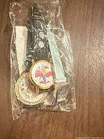 Bagged lot showing two wristwatches with distinct dials and strap colors