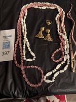 Full lot showing two bead necklaces and gold-tone earrings