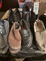 All four pairs of shoes displayed on table
