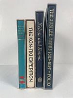 Four Folio Society hardcover books in slipcases stacked vertically showing spines: The Spanish Bawd, The Kon-Tiki Expedition, Nelson and Emma, The Jubilee Years 1887-1897.