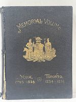 Front cover photo showing black leather with gold gilt embossed title and emblem.