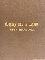 Close-up of 'Country Life in Canada, Fifty Years Ago' book cover showing brown cloth material and gilt titles.