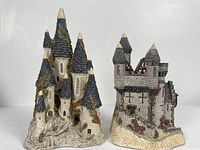 Front view of both David Winter Castles collectible sculptures showing detailed stonework and turret roofing