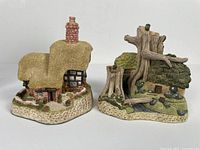 Front view of both cottages displayed side by side, showing detailed structures and textures.