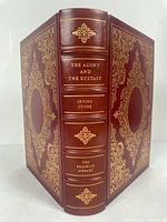 Photo of the book 'The Agony and The Ecstasy' showing the full leather burgundy cover with detailed gold embossing and gilded page edges.