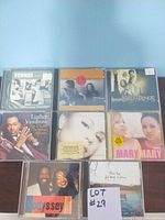 Photo showing nine CD jewel cases from the lot, featuring various artists like Common, Luther Vandross, Mary Mary, and a Lord of the Rings soundtrack CD.