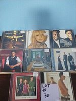 First photo showing 9 CD covers including Holly Cole, Michael Bublé, Peter Benson & Jarreau, Emjay, and others grouped in jewel cases.