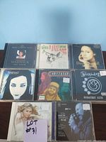 Photo showing 8 distinct CDs from various artists in jewel cases, including pop, rock, and jazz genres.