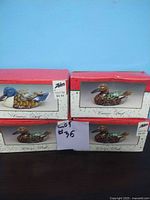 Four ceramic ducks in original Zellers boxes; three are identical brown-green ducks and one is a unique blue-headed duck, displayed against a blue background.