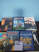 Photo of 7 DVDs including 'Hide and Seek', 'Deuce Bigalow', 'The Dilemma', 'Dragon's Greenpets of Perir Part 1', 'Fast Food Nation', and 'The Simpsons Movie'