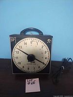 Front view of Gralab Universal Timer showing circular dial with hours marked 0 to 13 and control knob below.