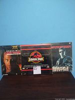 Photo of three laserdisc movie titles: Die Hard 2, Jurassic Park, Terminator 2 Judgment Day in original sleeves