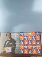 Two album sleeves showing The Latin World of Desmund Ros Vol 1 and The Best of Today's Country Hits compilation.