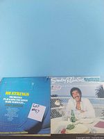 Photo of 101 Strings Orchestra and Smokey Robinson vinyl record covers showing part of the lot contents.