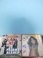 Photo of two vinyl record albums showing covers of George Baker Selection Paloma Blanca and Fiesta Caribe.