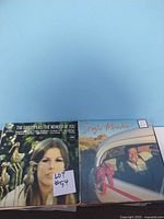 Photo showing two vinyl records, The Swappers 'The Wonder Of You' and a Sergio Mendes album, both with visible front covers and lot number tag.