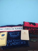 Image showing multiple embroidered golf towels and a branded notepad.