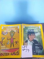Two National Geographic magazine covers with yellow borders: one with traditional tribal art, and one showing a woman in a hat.