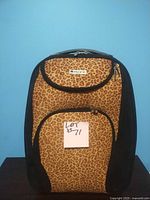 Front view of leopard print suitcase with black sides and a Pacific brand logo.