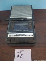 Front view of Panasonic cassette recorder/player showing control buttons and cassette compartment with clear cover.