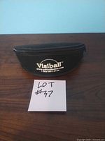 Black zippered carrying case with the Visiball logo and contact info on it.