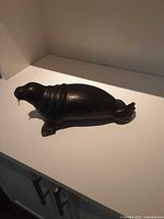 Side view of Inuit walrus carving showing body contour and flippers