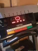 Close-up of treadmill digital display with LED readout and control buttons.