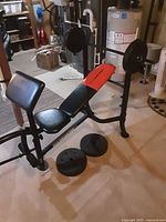 Side angle view of WeiderPro weight bench with barbell equipped with weight plates and additional plates on floor