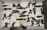 Box containing 25 painted WW1 British lead miniature soldiers in assorted combat poses.
