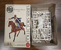 Opened box with plastic sprue parts and some assembled pieces for British 10th Hussar 1815 miniature model kit by Airfix.