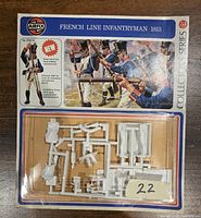 Plastic sprues with parts for 54mm infantryman figure in sealed Airfix Collectors Series blister pack, with colorful card showing soldiers in blue uniforms.