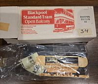 Photo of the plastic parts and parts sheet inside a clear plastic bag, with box label showing brand and model details.