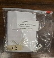 Sealed plastic bag contains folded white fabric pieces, small white accessory parts and paper instructions labeled with Historex kit number and designation.