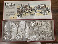 Open box showing plastic parts in bags for artillery and cavalry miniatures in 1/32 scale.