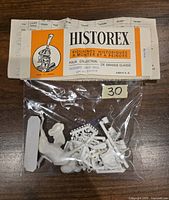 Photo of the Historex miniature kit parts in a clear plastic bag with label showing brand and model name Hussard 1805-1813 and package details.