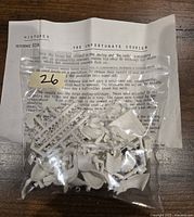 Photo showing white plastic miniature parts for 'The Unfortunate Courier' by Historex in a clear plastic bag with printed original instruction sheet.